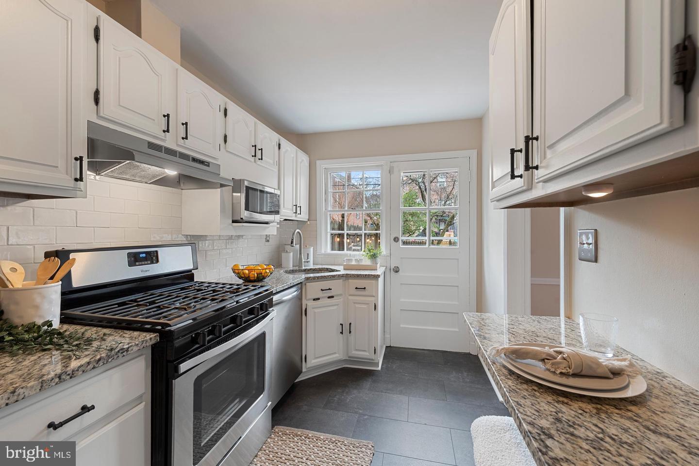 183 Stanmore Road Baltimore, MD 21212 - Photo 6 of 32 a kitchen with stainless steel appliances granite countertop a stove a sink and a refrigerator