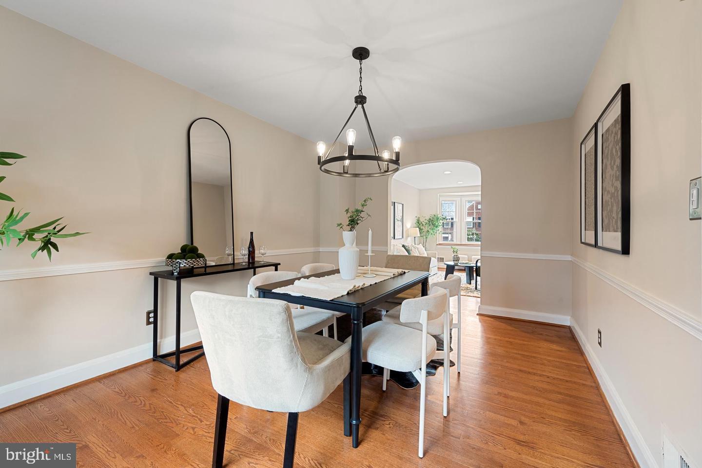183 Stanmore Road Baltimore, MD 21212 - Photo 10 of 32 a dining room with wooden floor a chandelier a wooden table and chairs