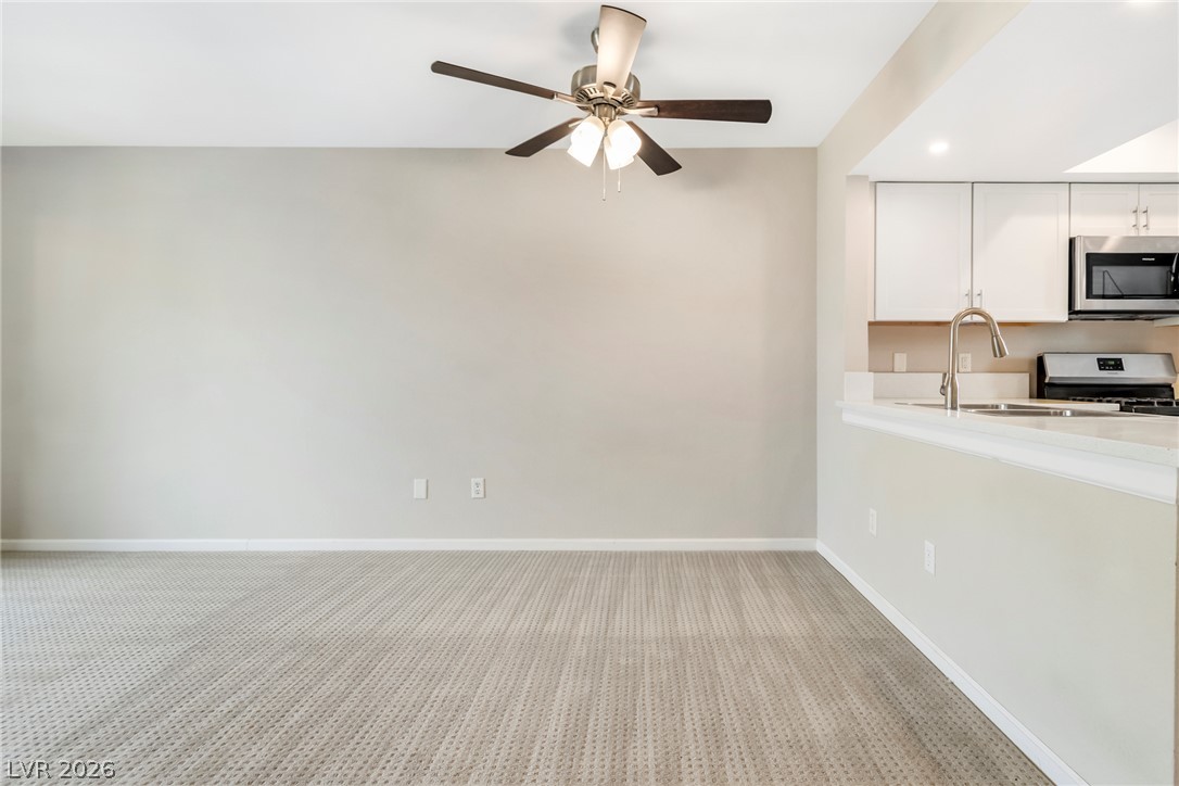 8070 West Russell Road, Unit 2006 Las Vegas, NV 89113 - Photo 9 of 24 Well-appointed living space flows into a modern kitchen, ideal for effortless entertaining.