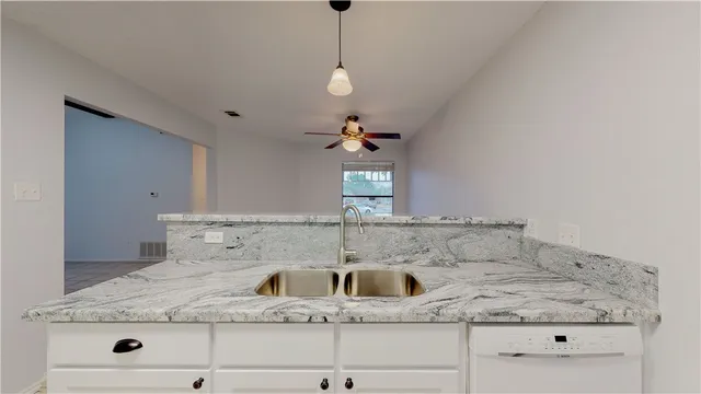 a kitchen with stainless steel appliances white cabinets and a refrigerator