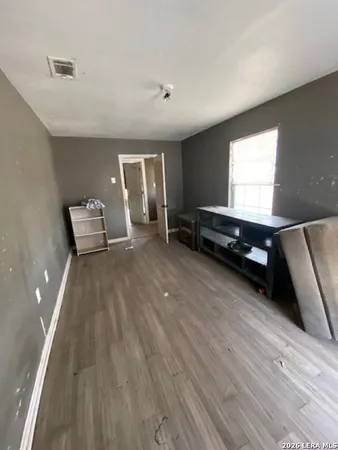 a view of a room with furniture and a window