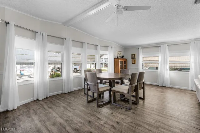 a view of a dining room with furniture and window
