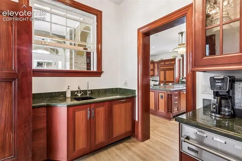 a kitchen with granite countertop stove and sink