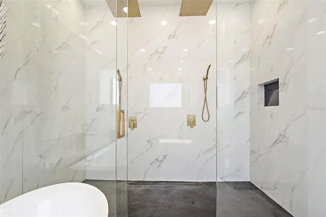 a bathroom with a granite countertop shower