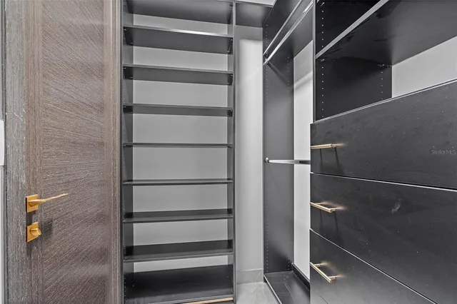 an empty room with furniture and flat screen tv