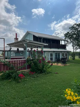 a front view of a house with a yard table and chairs