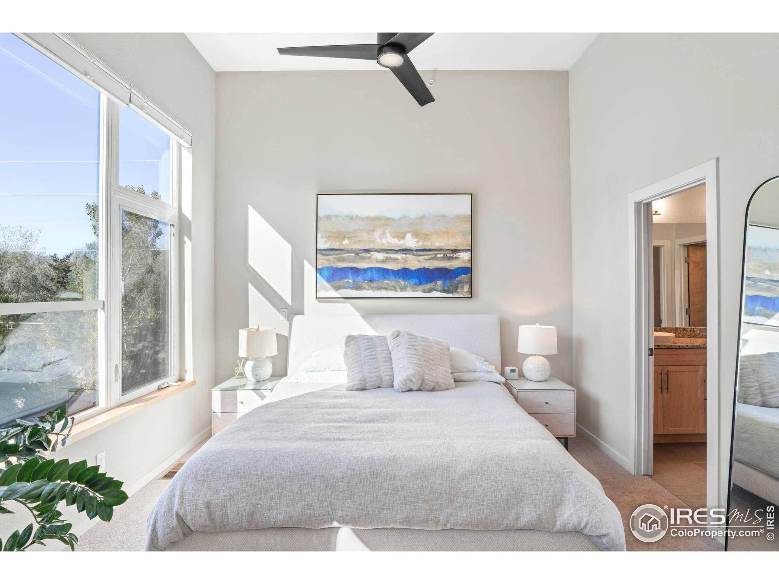 4190 Longview Lane Boulder, CO 80301 - Photo 16 of 25 a bedroom with a large bed and a painting on the wall