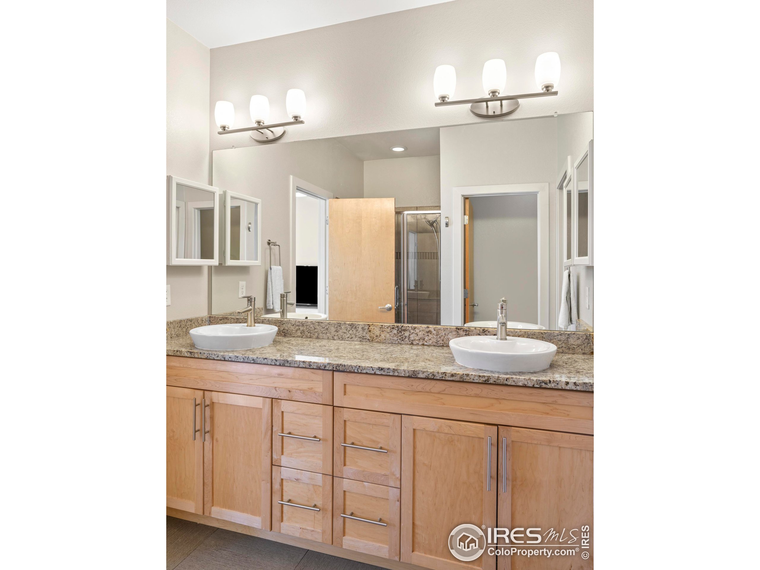 4190 Longview Lane Boulder, CO 80301 - Photo 19 of 25 a bathroom with a granite countertop sink and a mirror
