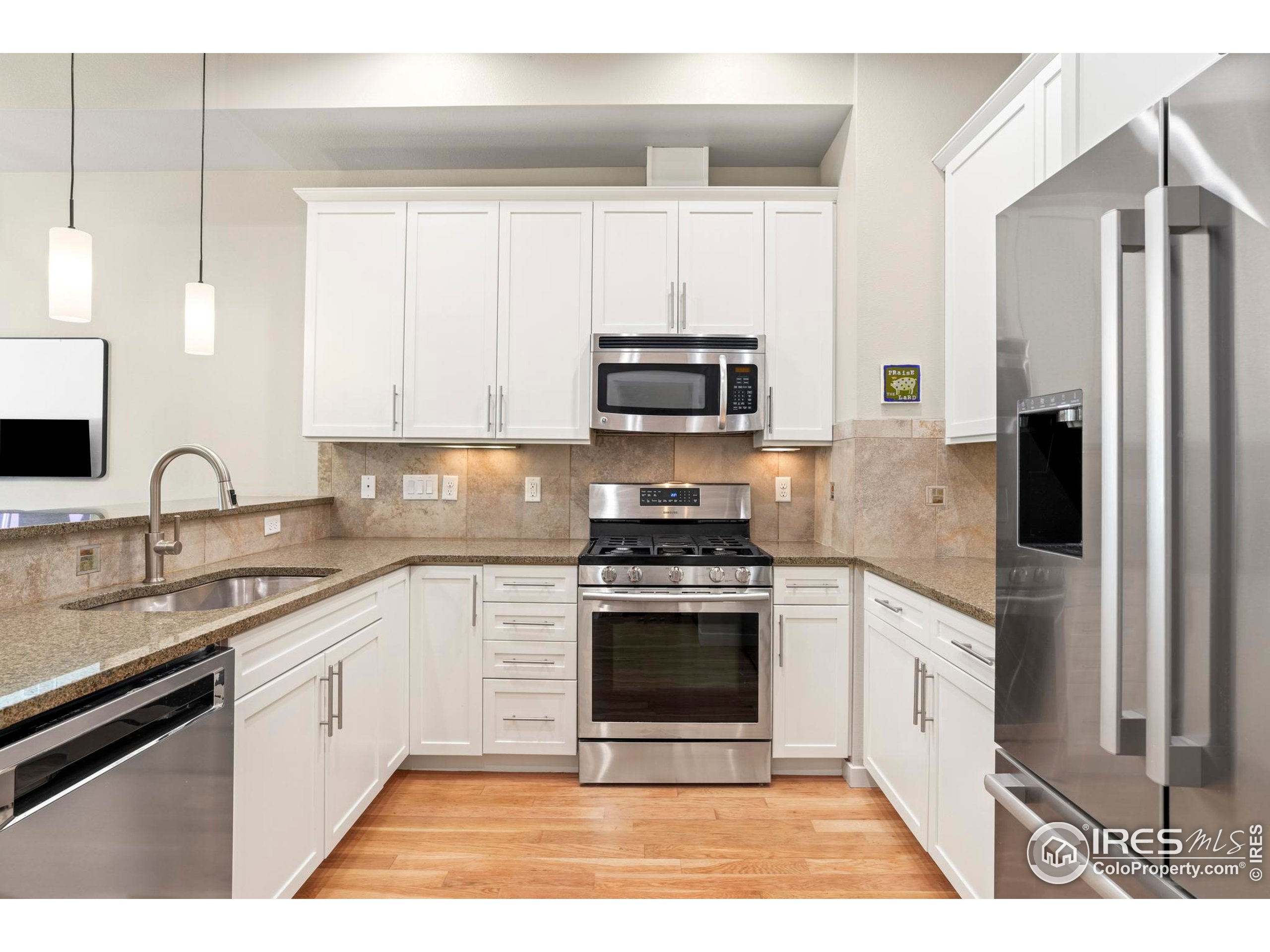 4190 Longview Lane Boulder, CO 80301 - Photo 9 of 25 a kitchen with stainless steel appliances granite countertop a stove a sink and a refrigerator
