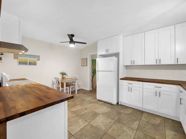 a kitchen with cabinets and refrigerator