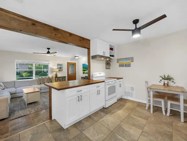 a kitchen with granite countertop cabinets a sink and appliances