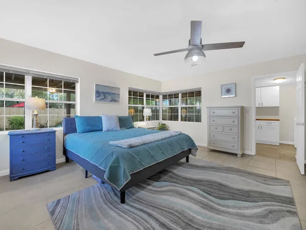a bedroom with furniture and a large window