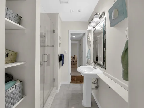 a white toilet sitting next to a bathroom sink and vanity
