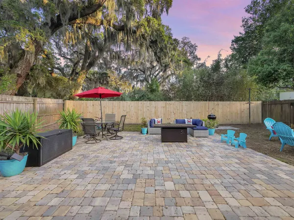 a backyard of a house with table and chairs