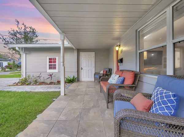 a view of a house with backyard sitting area and garden