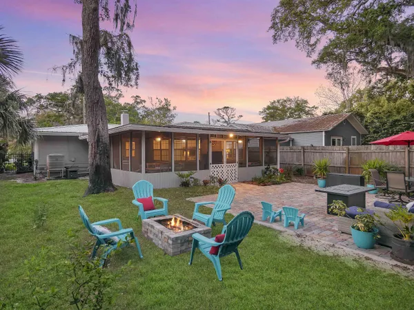 a view of a house with backyard sitting area and garden
