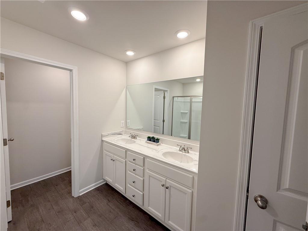 276 Whitetail Circle Canton, GA 30115 - Photo 23 of 40 a bathroom with a double vanity sink and mirror