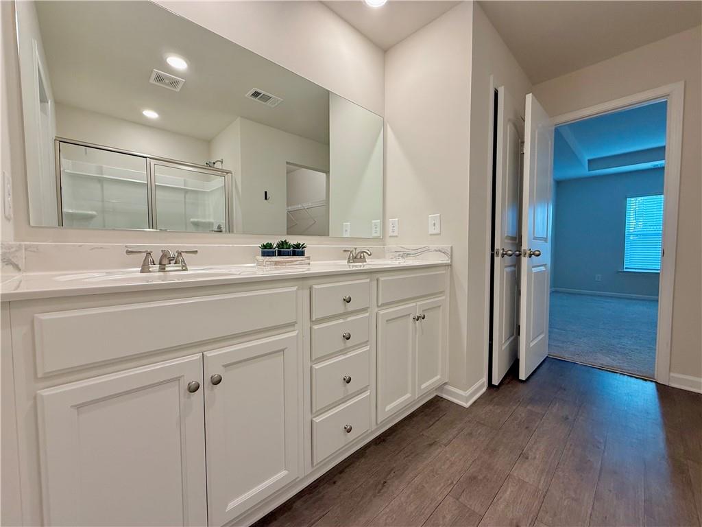 276 Whitetail Circle Canton, GA 30115 - Photo 24 of 40 a bathroom with a double vanity sink and mirror