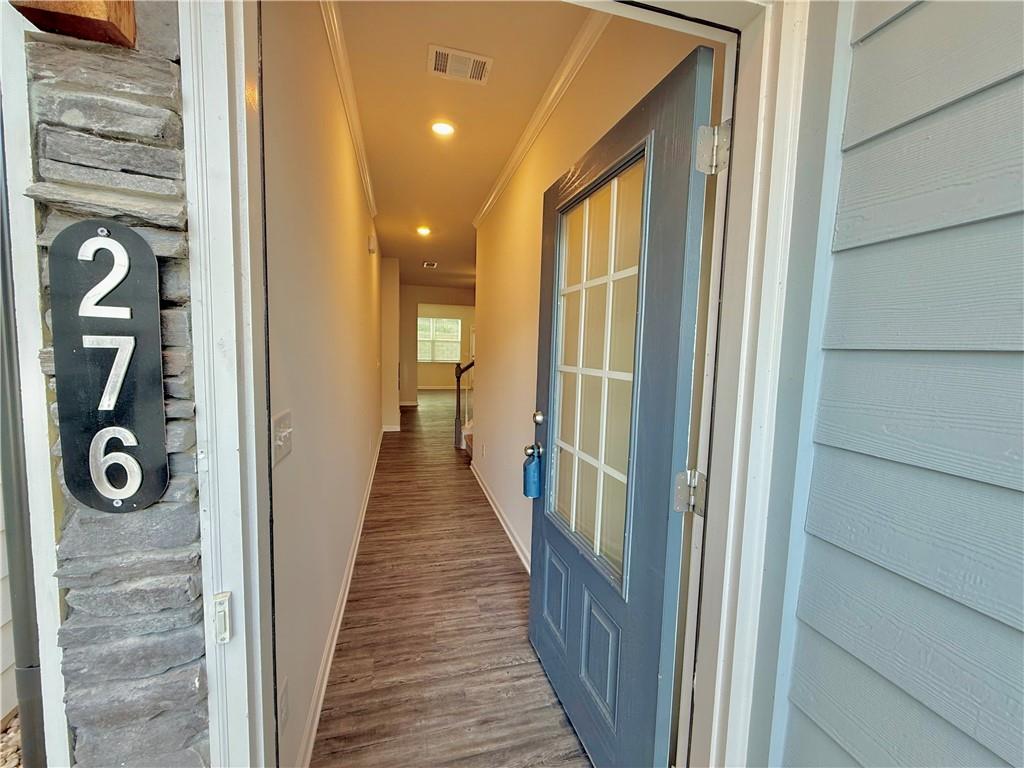 276 Whitetail Circle Canton, GA 30115 - Photo 3 of 40 a view of a hallway with wooden floor and staircase
