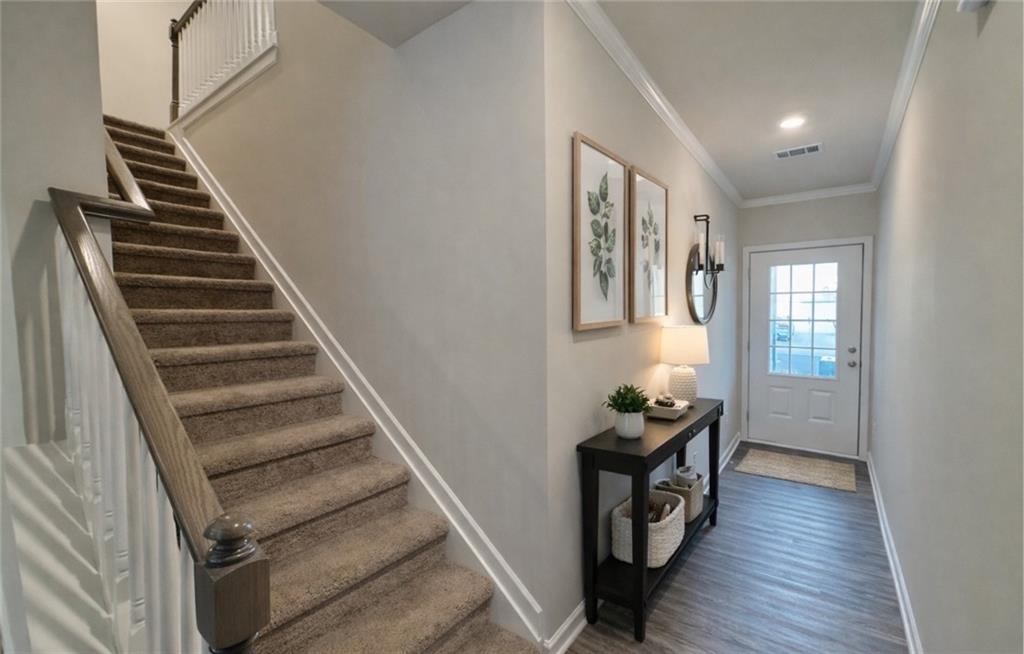 276 Whitetail Circle Canton, GA 30115 - Photo 4 of 40 a view of a hallway with wooden floor and staircase