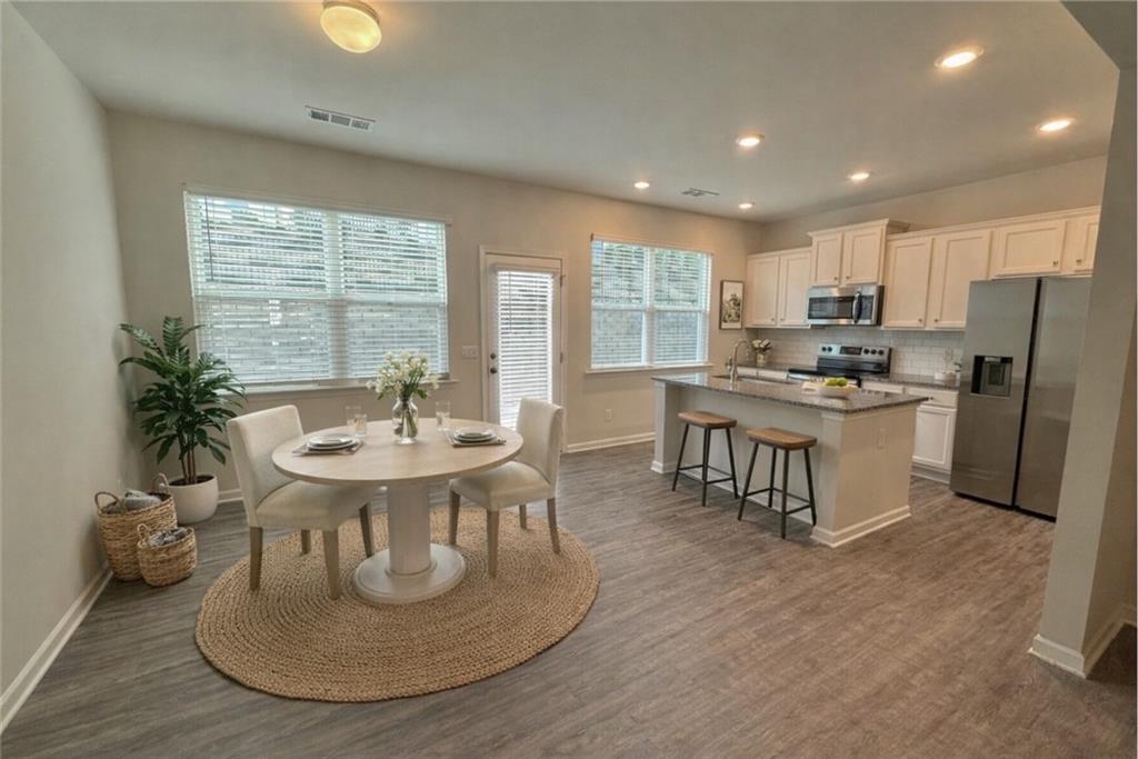 276 Whitetail Circle Canton, GA 30115 - Photo 6 of 40 a kitchen with a table chairs stove and refrigerator