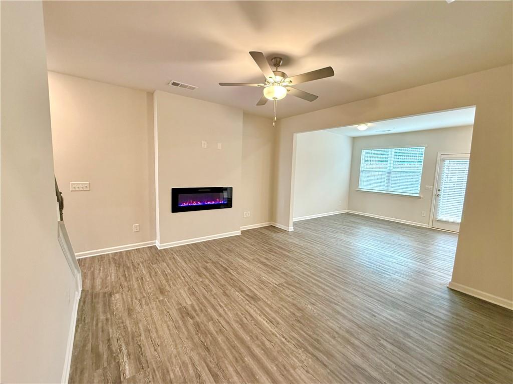 276 Whitetail Circle Canton, GA 30115 - Photo 9 of 40 a view of an empty room with wooden floor and a window