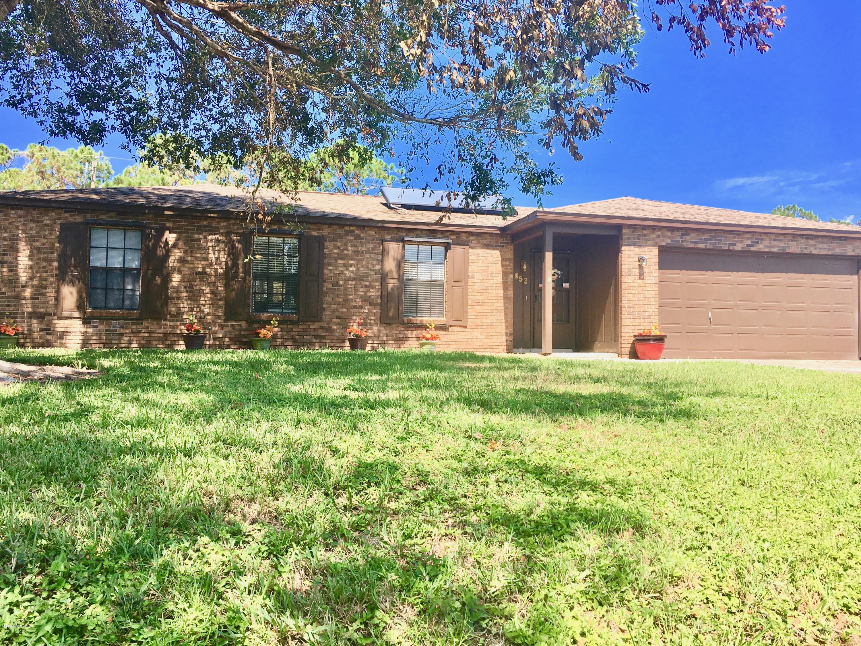 853 Furth Road Northwest Palm Bay, FL 32907 - Photo 1 of 29 a front view of a house with garden