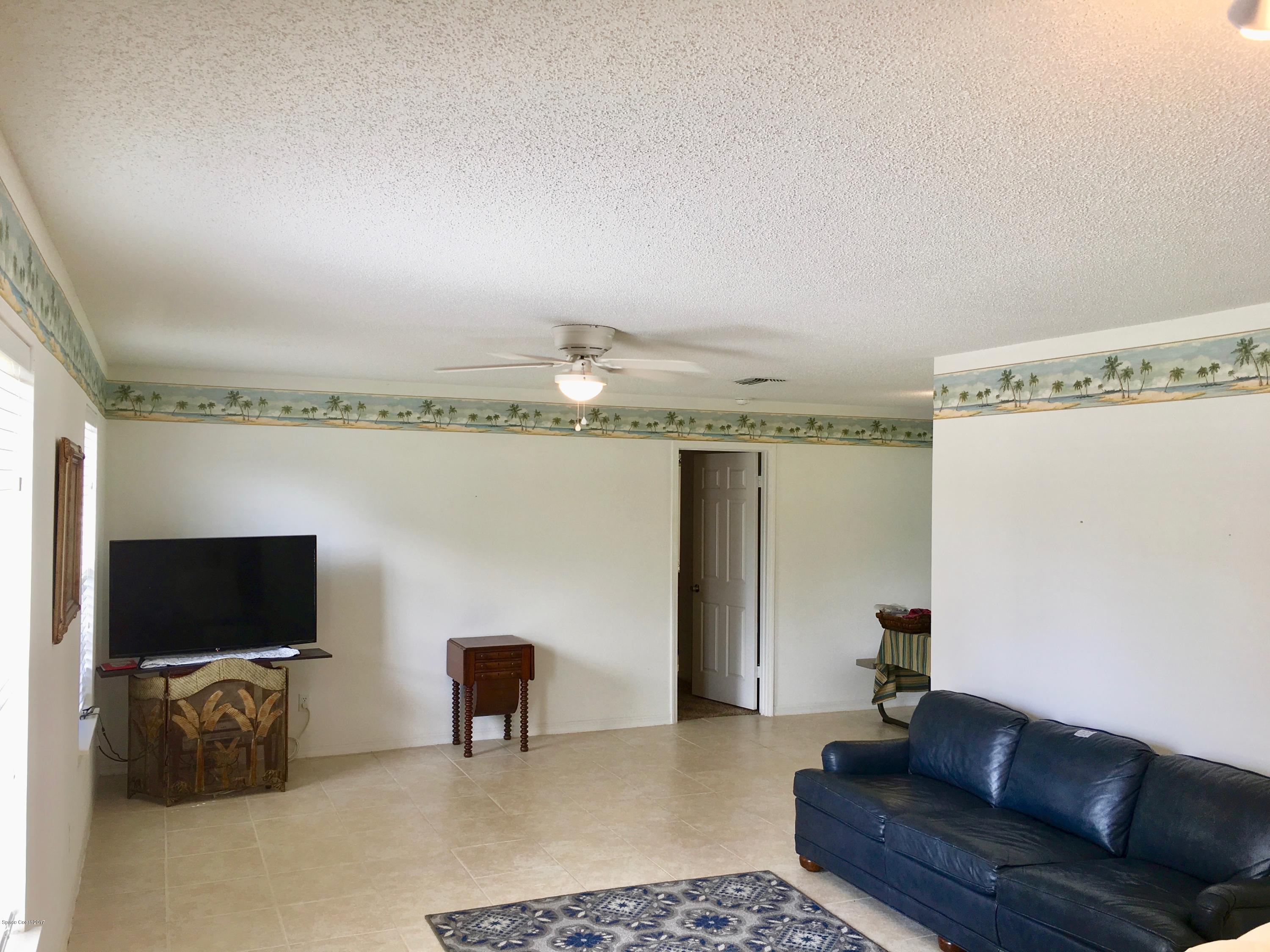 853 Furth Road Northwest Palm Bay, FL 32907 - Photo 12 of 29 a living room with furniture and a flat screen tv
