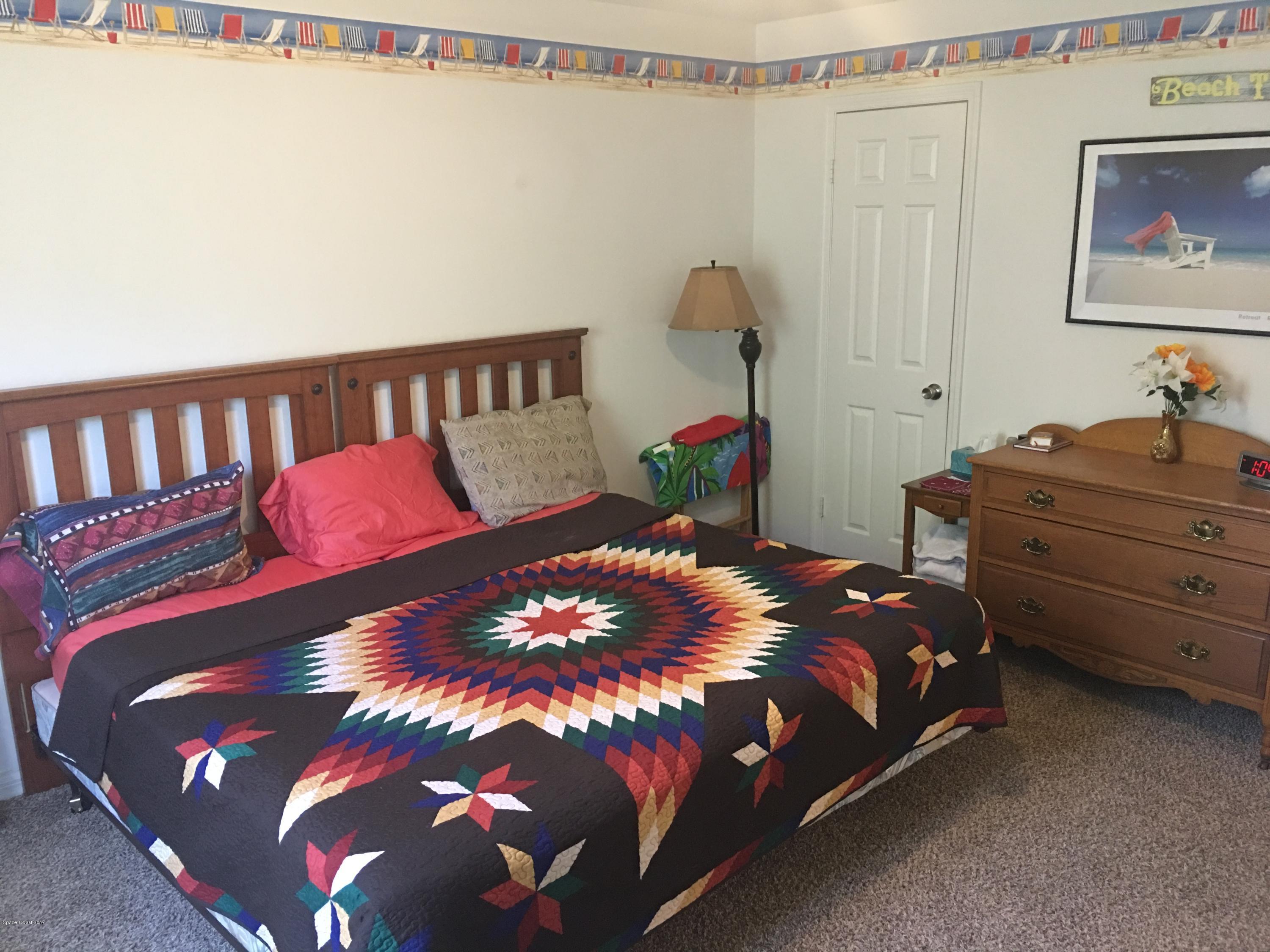 853 Furth Road Northwest Palm Bay, FL 32907 - Photo 17 of 29 a large bed sitting in a bedroom next to a cabinet