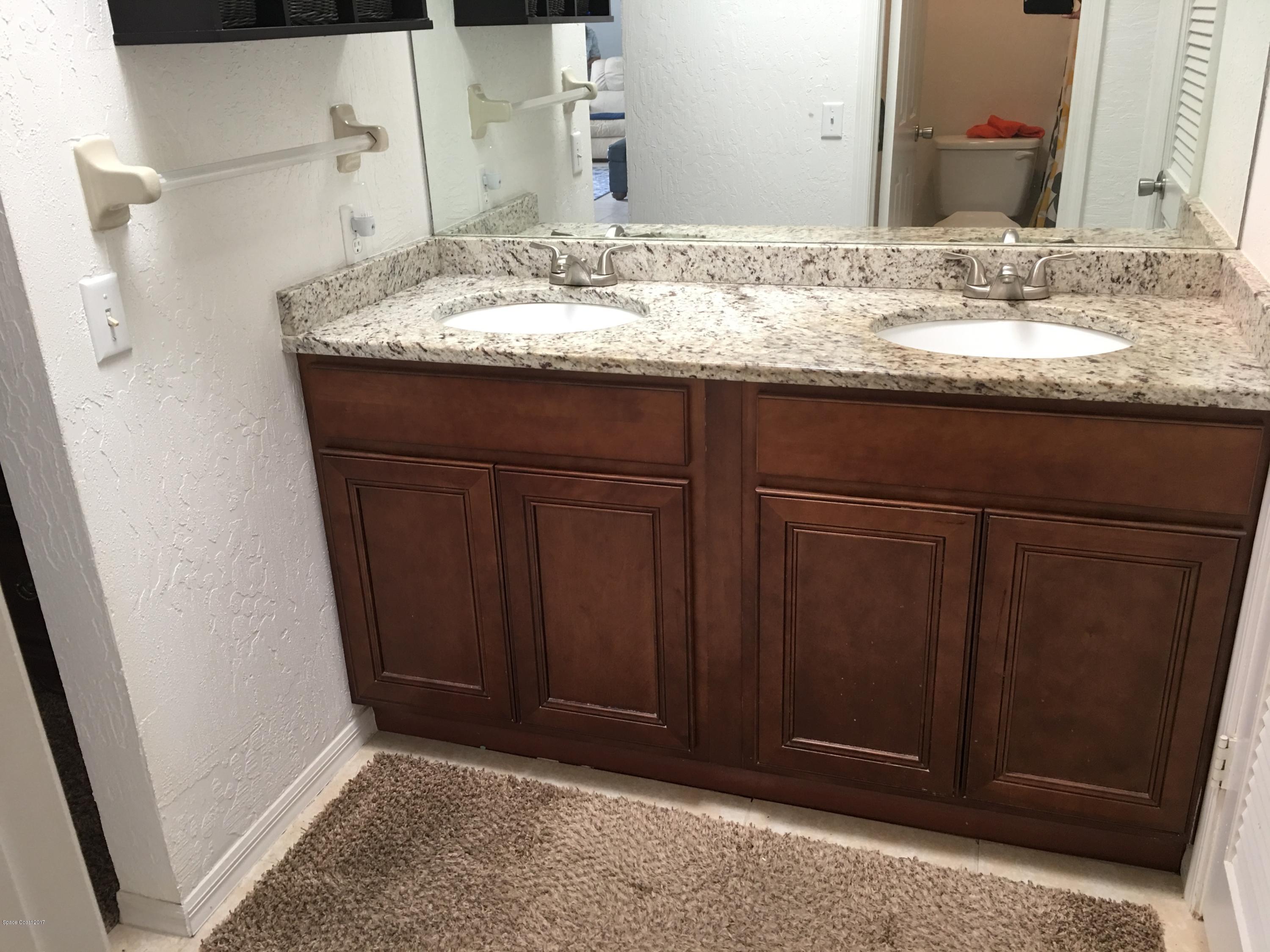 853 Furth Road Northwest Palm Bay, FL 32907 - Photo 18 of 29 a bathroom with a granite countertop sink and a mirror