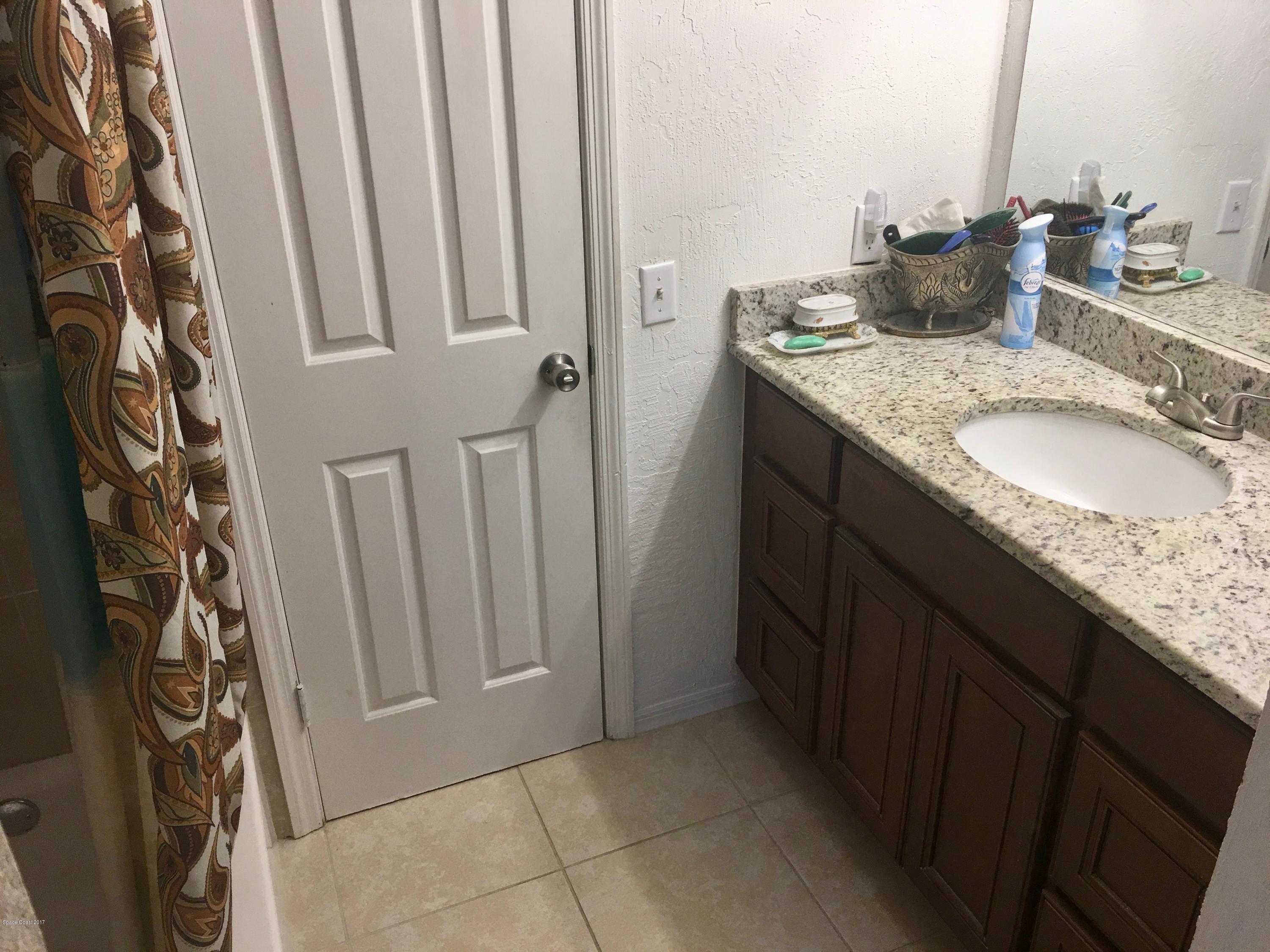 853 Furth Road Northwest Palm Bay, FL 32907 - Photo 20 of 29 a bathroom with a granite countertop sink and a mirror