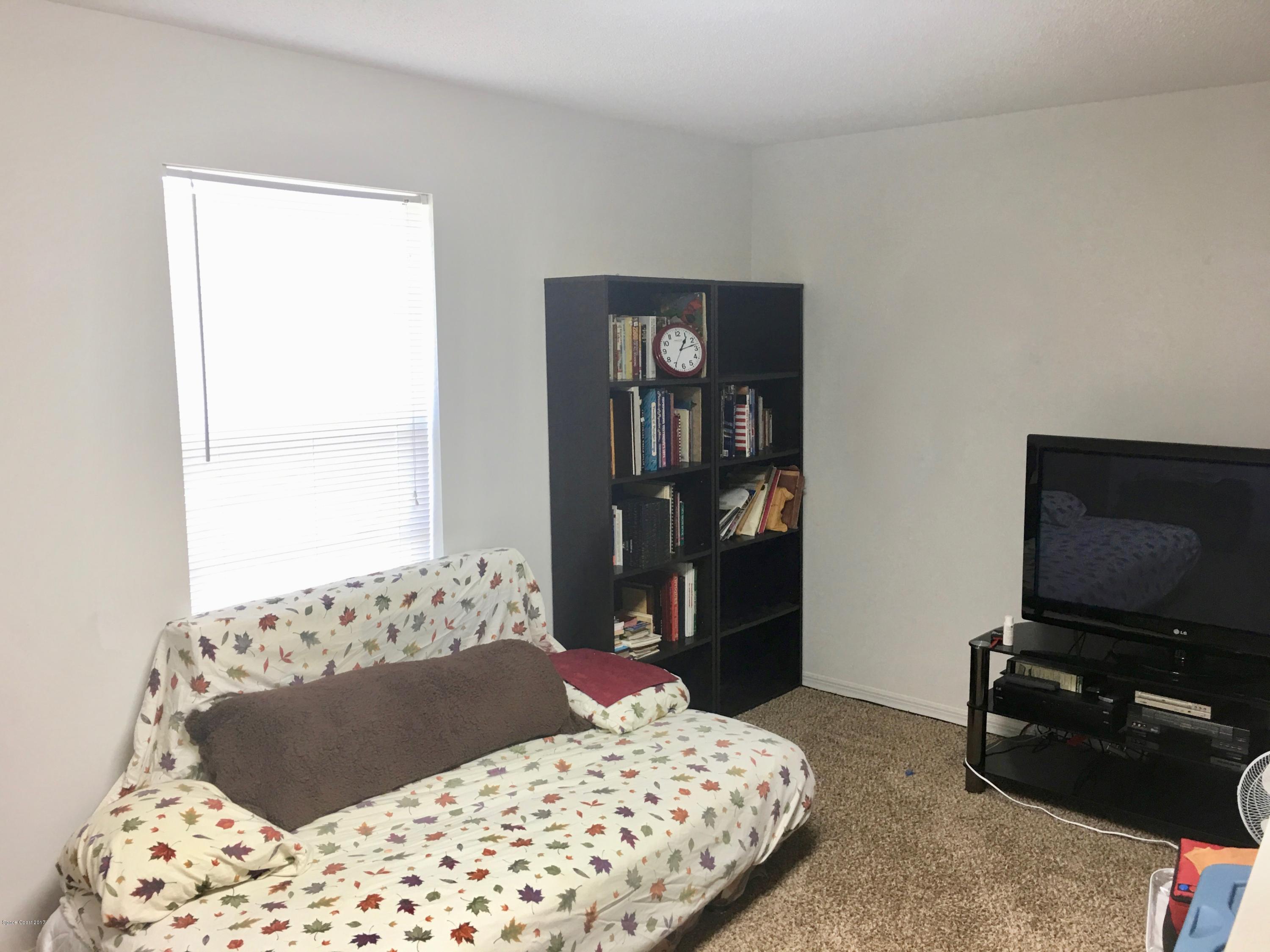 853 Furth Road Northwest Palm Bay, FL 32907 - Photo 23 of 29 a bedroom with a bed and a television