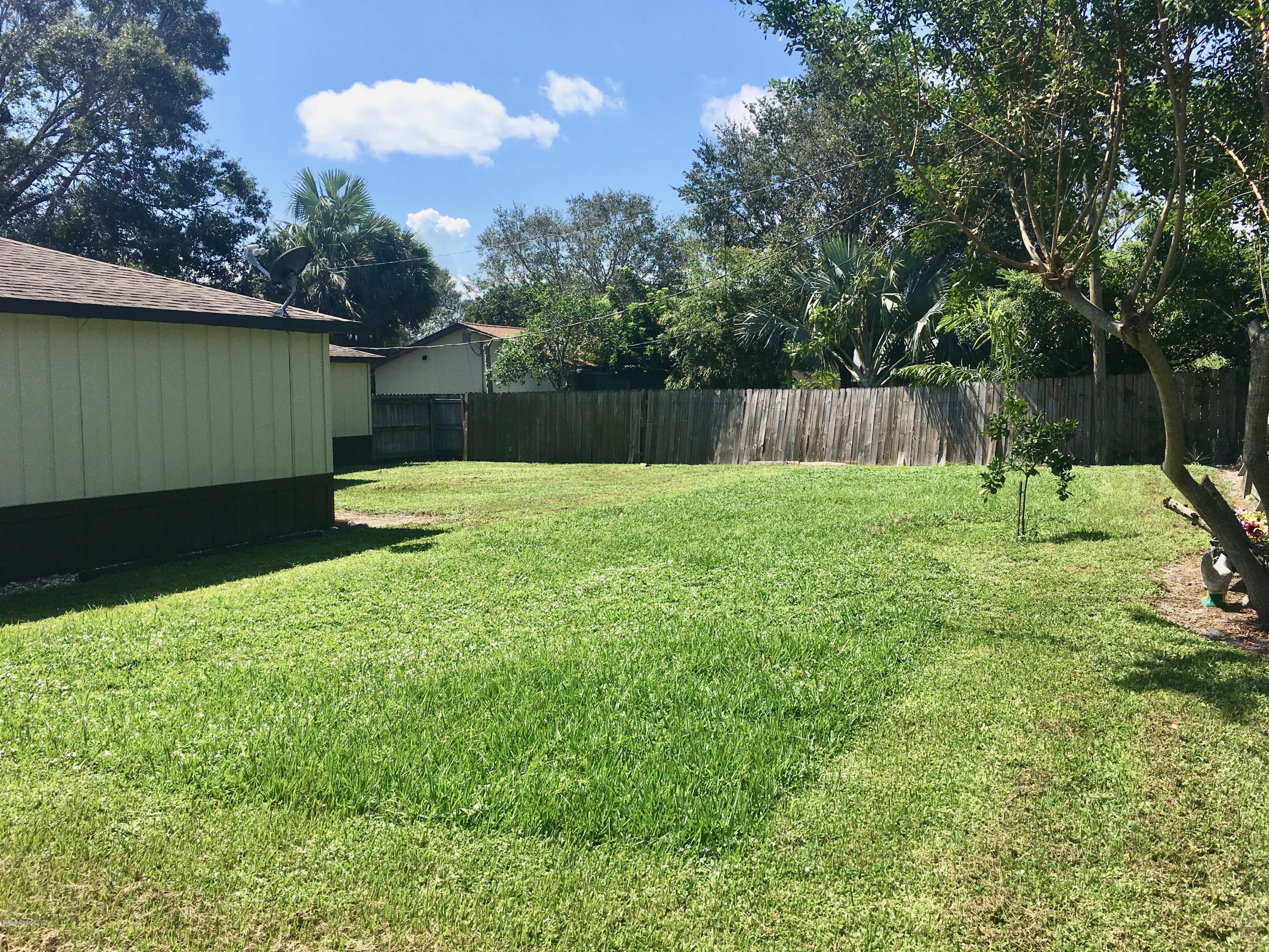 853 Furth Road Northwest Palm Bay, FL 32907 - Photo 28 of 29 a view of backyard with table and chairs