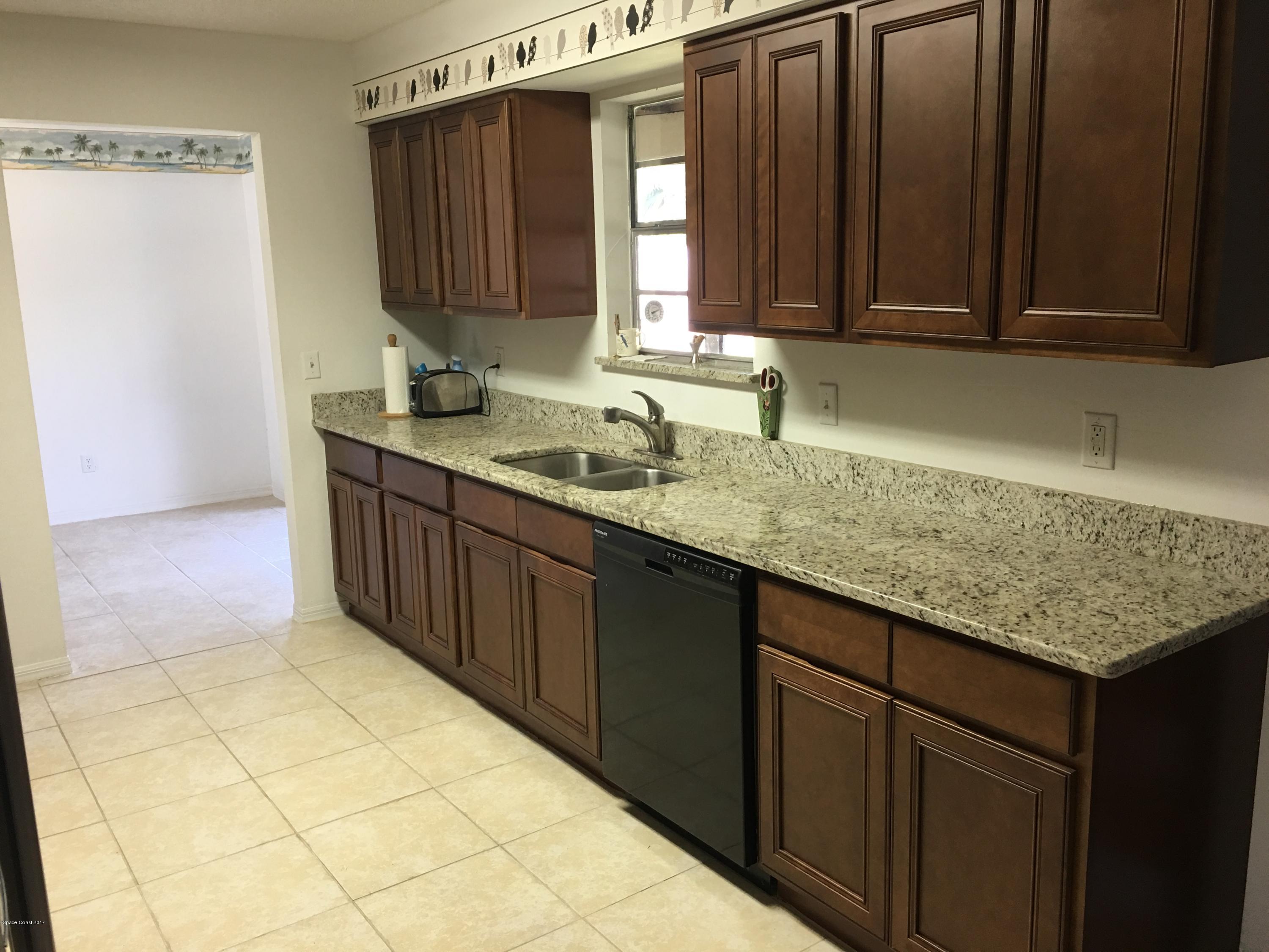 853 Furth Road Northwest Palm Bay, FL 32907 - Photo 5 of 29 a kitchen with stainless steel appliances granite countertop a sink and cabinets