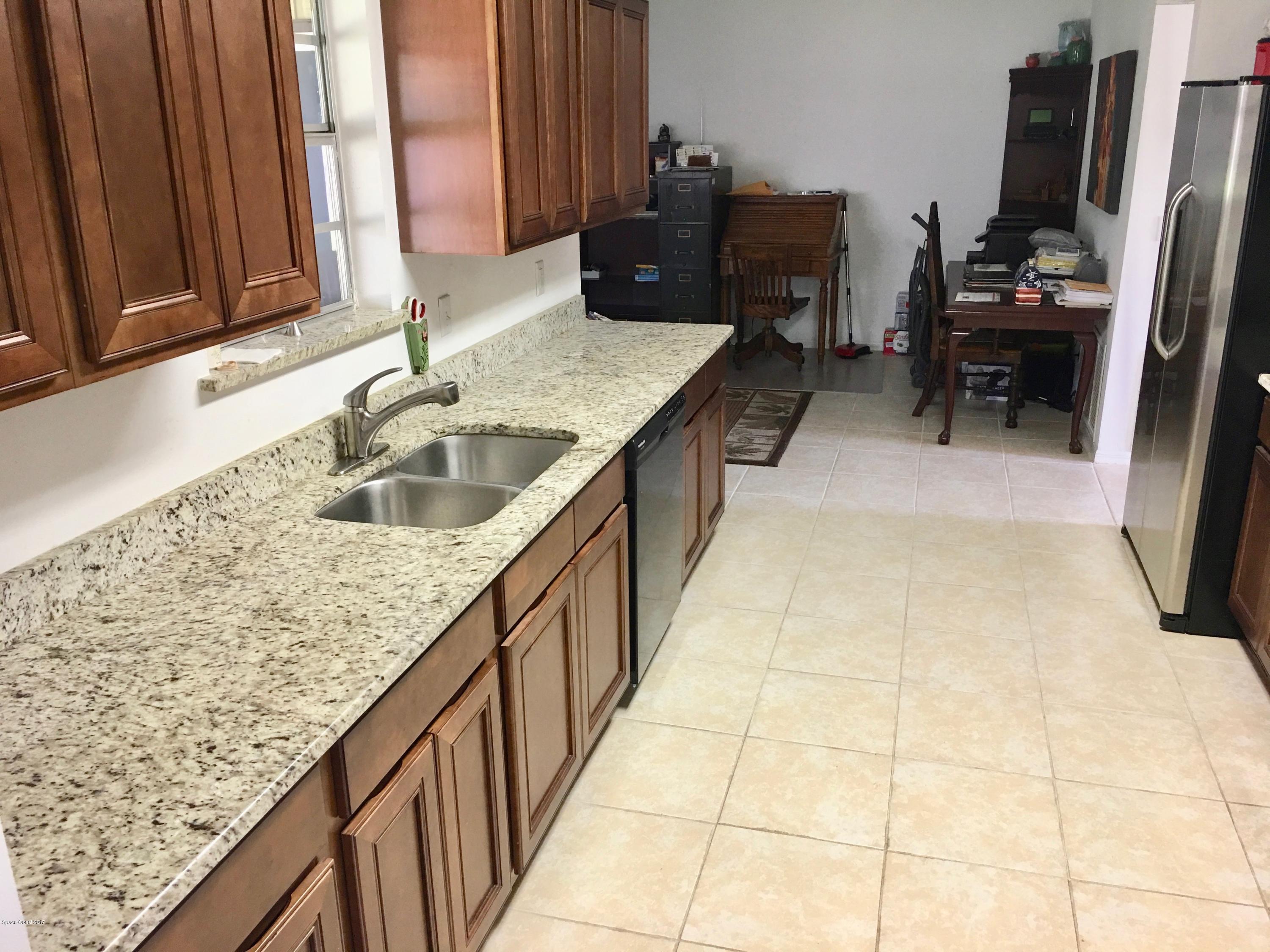 853 Furth Road Northwest Palm Bay, FL 32907 - Photo 7 of 29 a kitchen with granite countertop a sink and a stove