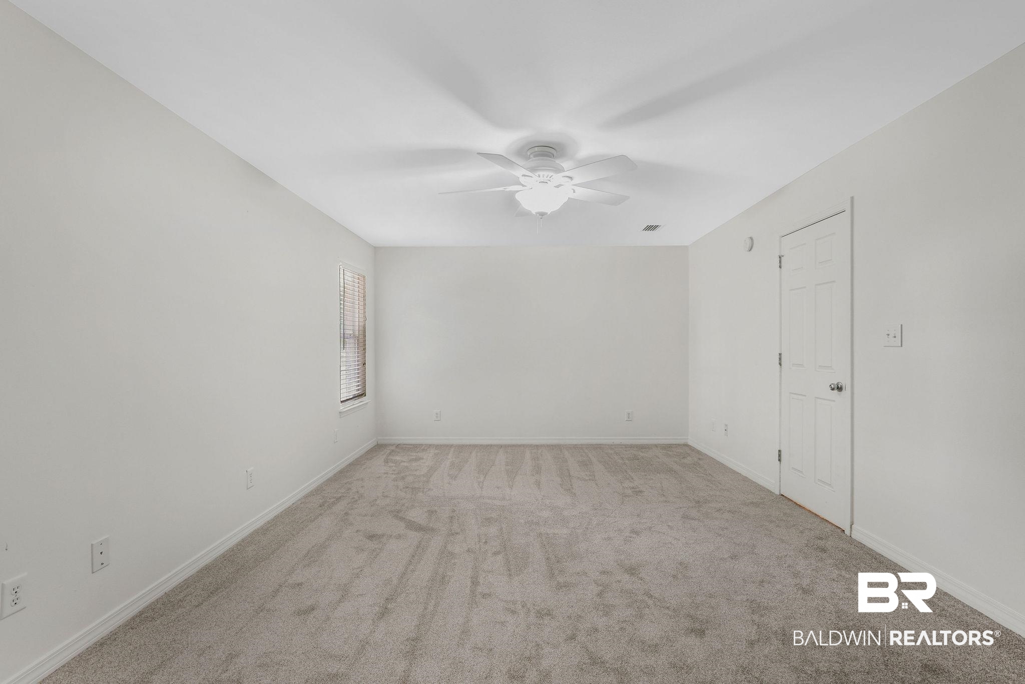 18620 Hammond Street Robertsdale, AL 36567 - Photo 9 of 23 Carpeted empty room with ceiling fan