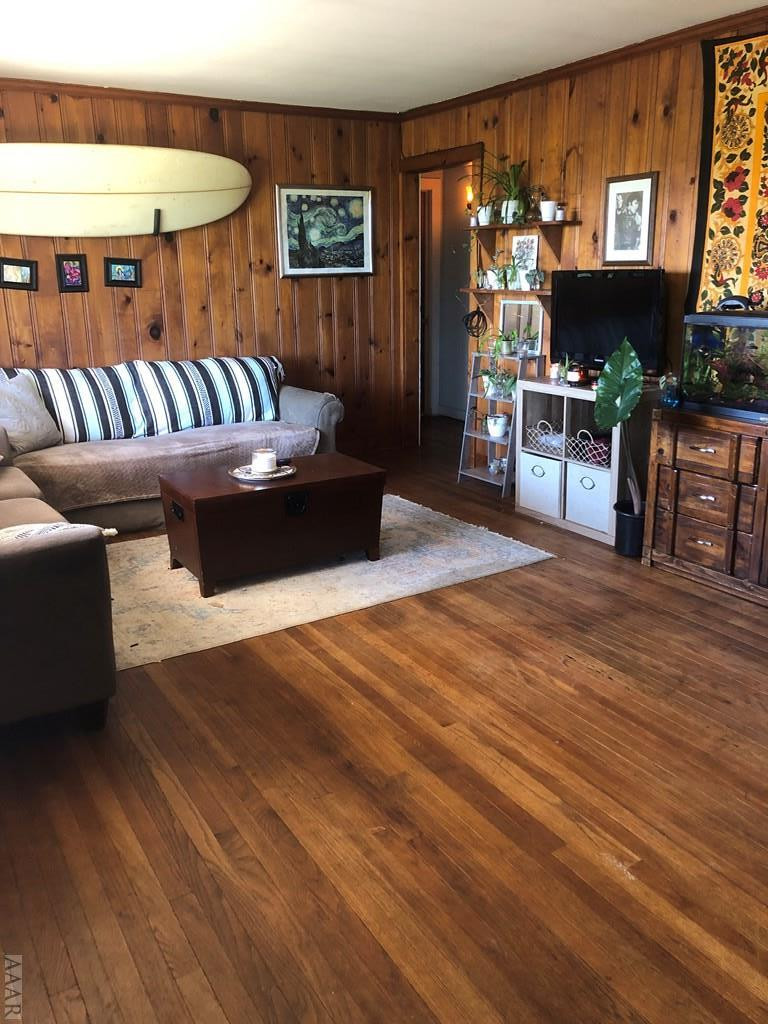 177 Cason Point Road Knotts Island, NC 27950 - Photo 10 of 13 Living room--nice wood floors and paneling.