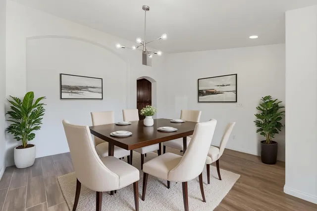 a spacious bedroom with a bed and a flat screen tv