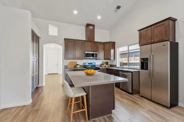 a front view of a house with a yard and potted plants