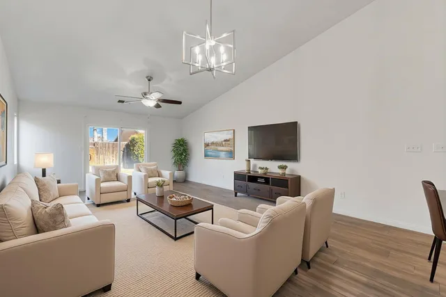 a view of a room with wooden floor and white walls