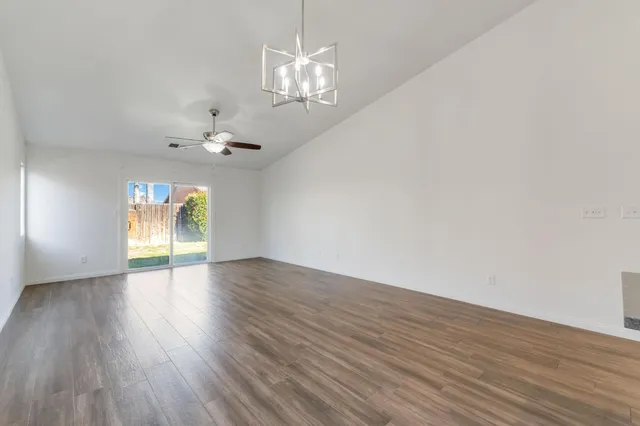 a bedroom with a bed and a lamp on the dresser