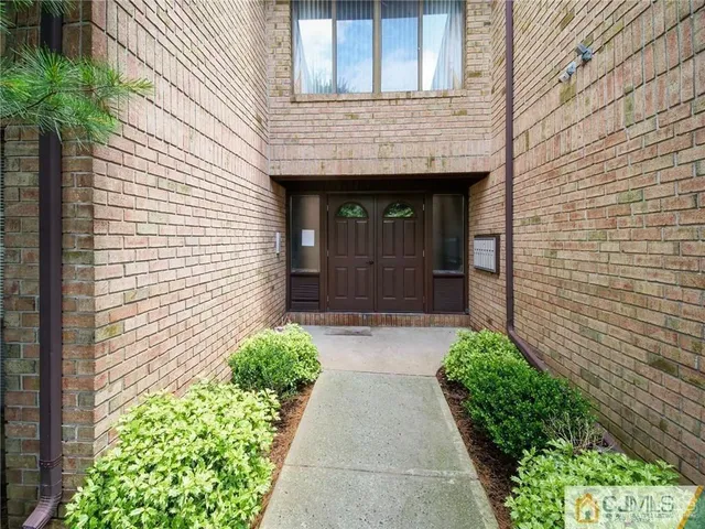 a stone house with potted plants in front of door