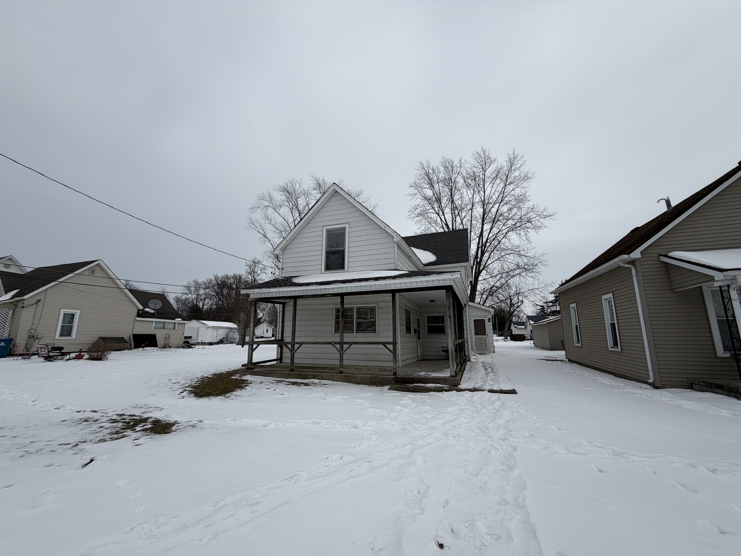 a view of a house with a snow in the yard