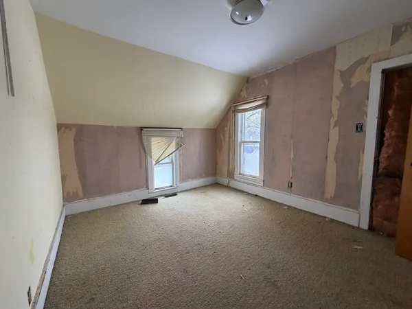 an empty room with windows and closet