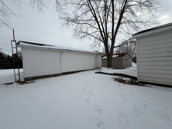 a view of a garage with wooden fence