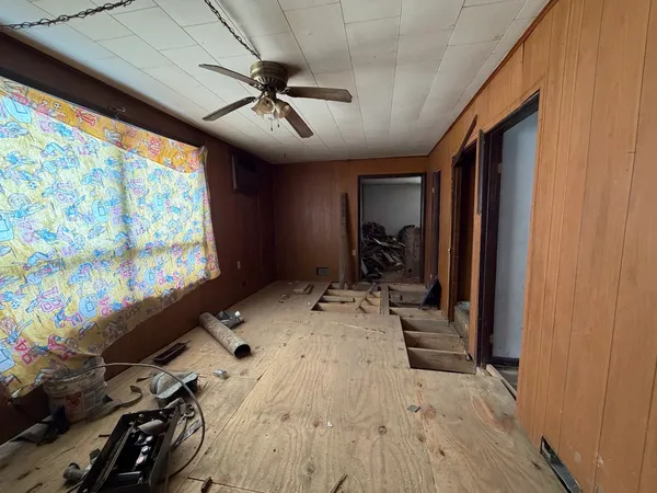 a view of a livingroom with furniture and a window
