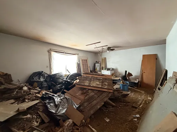 a living room with furniture a flat screen tv and a window