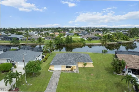 an aerial view of a house with yard swimming pool and outdoor seating