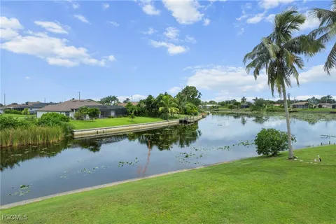 a view of a lake with houses in the back