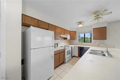 a kitchen with stainless steel appliances a refrigerator sink and microwave